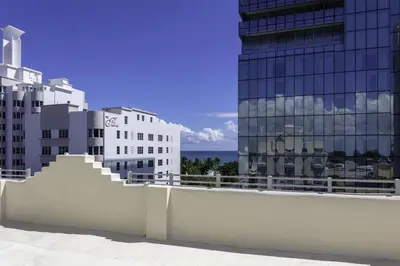 a white fence in front of some buildings at Hilton Garden Inn Miami South Beach in Miami Beach