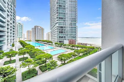 a balcony with a pool and trees and buildings at Unique 1BR Icon Brickell WaterViews-Freespa in Miami