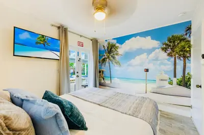 a bedroom with a bed and a view of the ocean at Coastal Paradise Retreat- Mini Golf, 4 Bedrooms, Game Room, Htd Pool, BBQ Fire Pit in Hollywood
