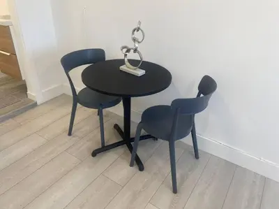 a black table with two chairs and a lamp on it at Excellent location Miami Brickell Studio in Miami