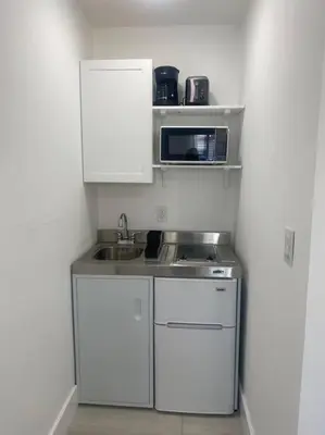 a small kitchen with a sink and a microwave at Excellent location Miami Brickell Studio in Miami