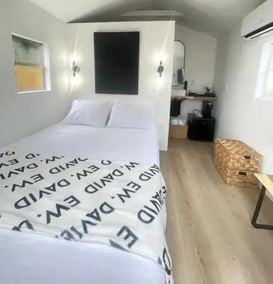a bedroom with a bed and a tv on the wall at Charming Coastal Retreat in Miami