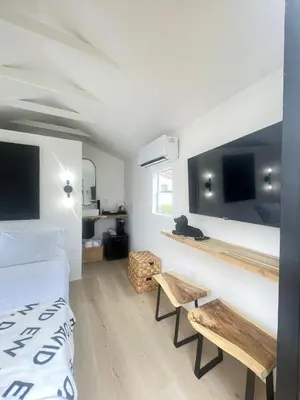 a bedroom with a bed and two benches in it at Charming Coastal Retreat in Miami