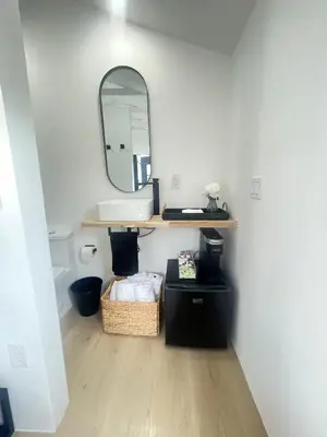 a bathroom with a sink and a mirror at Charming Coastal Retreat in Miami