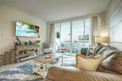 a living room with a couch and a table at GalleryOne Doubletree Hilton GC Turtle Cove in Fort Lauderdale
