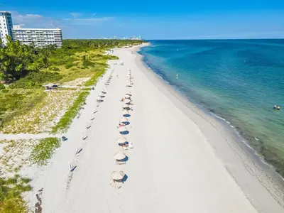 an overhead view of a beach with umbrellas and the ocean at Tropical Retreat with Beach Resort Amenities in Miami