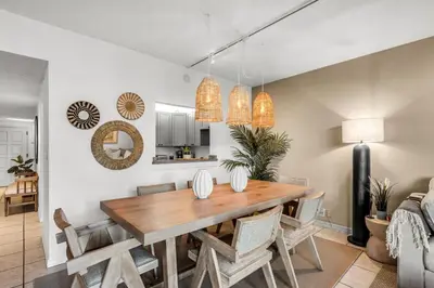 a kitchen and dining room with a wooden table and chairs at Tropical Retreat with Beach Resort Amenities in Miami
