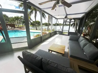 a living room with a couch and a pool at Inactive 193 Modern, 4B&3B with Pool and Lake in Pembroke Pines