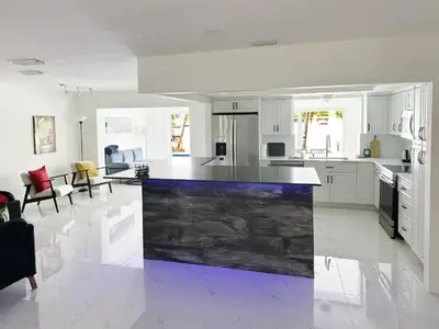 a large white kitchen with a large island in the middle at Inactive 193 Modern, 4B&3B with Pool and Lake in Pembroke Pines