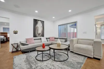 a living room with a couch and two tables at Beautiful Tropical Vacation House close to Beach in Hollywood