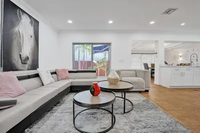 a living room with a couch and two tables at Beautiful Tropical Vacation House close to Beach in Hollywood