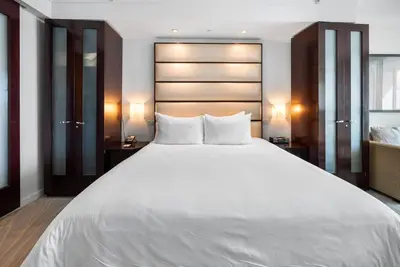 a large white bed with two pillows in a room at FontaineBleau, Balcony w Ocean plus Bay and City View in Miami Beach