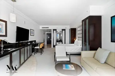 a large living room with a bed and a couch at FontaineBleau, Balcony w Ocean plus Bay and City View in Miami Beach