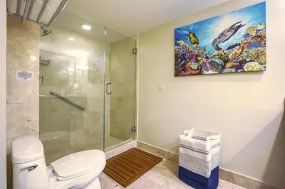 a bathroom with a shower and a toilet and a painting at GalleryOne Doubletree Hilton GC Secret Blending in Fort Lauderdale