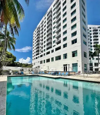 a large building with a swimming pool in front of a building at GalleryOne Doubletree Hilton GC Secret Blending in Fort Lauderdale