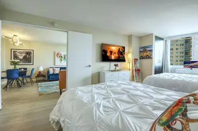 a bedroom with a bed and a living room at GalleryOne Doubletree Hilton GC Secret Blending in Fort Lauderdale