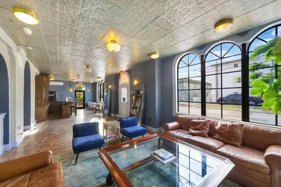 a living room with a couch and a glass table at Tower Hotel Little Havana in Miami