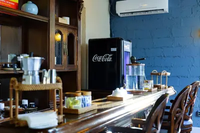 a bar with a cold drink refrigerator on a counter at Tower Hotel Little Havana in Miami