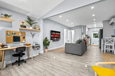 a living room with a desk and a couch at Zen Retreat - Sauna Pool Cold Plunge & More in Fort Lauderdale