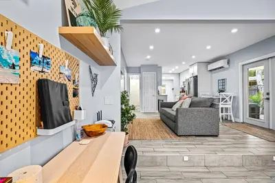 a living room with a couch and a table at Zen Retreat - Sauna Pool Cold Plunge & More in Fort Lauderdale