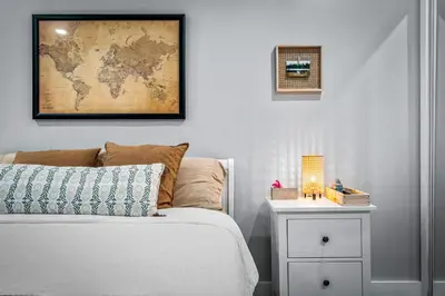 a bedroom with a bed and a map on the wall at Zen Retreat - Sauna Pool Cold Plunge & More in Fort Lauderdale