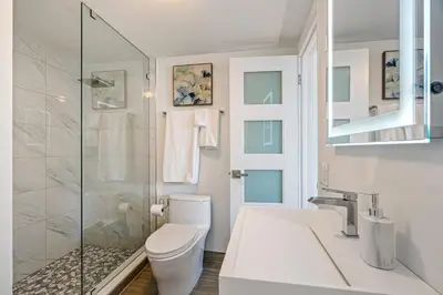 a bathroom with a toilet and a glass shower at Walk to Ft Lauderdale beach - Water Views & Pool in Fort Lauderdale
