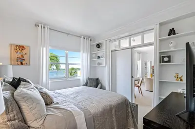 a white bedroom with a bed and a window at Walk to Ft Lauderdale beach - Water Views & Pool in Fort Lauderdale