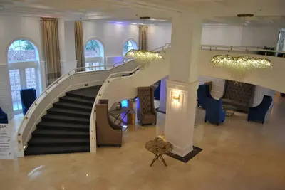 a spiral staircase in a building with chairs and tables at Luxury Beachfront 3 Bedroom Miami Beach Condo, in Miami Beach