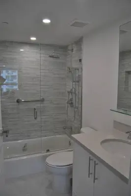 a bathroom with a shower and a toilet and a sink at Luxury Beachfront 3 Bedroom Miami Beach Condo, in Miami Beach