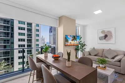 a living room with a table and a couch at Beautiful Studio Amazing Pool Gym Bar and Spa in Miami