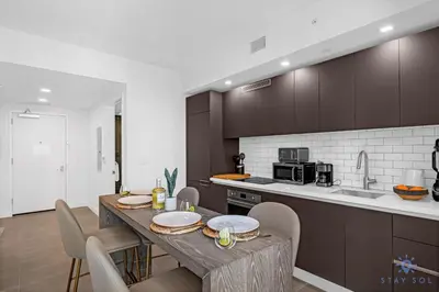 a kitchen with a table and some chairs in a room at Beautiful Studio Amazing Pool Gym Bar and Spa in Miami