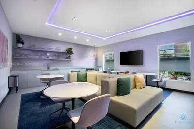 a living room with a couch and a table at Beautiful Studio Amazing Pool Gym Bar and Spa in Miami