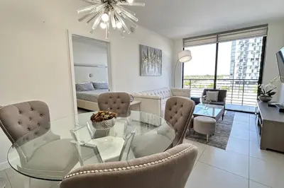 a living room with a glass table and chairs at Resort Style Luxury Living in Doral, Miami in Miami