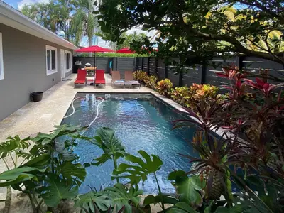 a swimming pool in the backyard of a house at Riverbank Guesthouse Wilton Manors in Fort Lauderdale