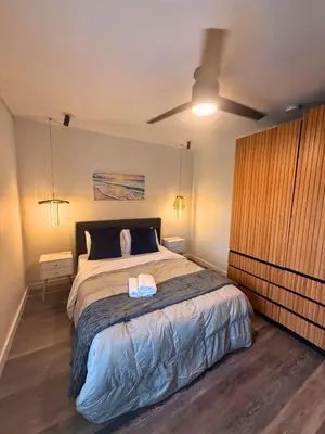 a bedroom with a bed and a ceiling fan at Luxury RiverFront By Renzzi in Miami