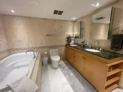 a bathroom with a tub and a toilet and a sink at Ocean front 2 Bedroom and 2 Bathroom apartment at The Alexander Resort in Miami Beach