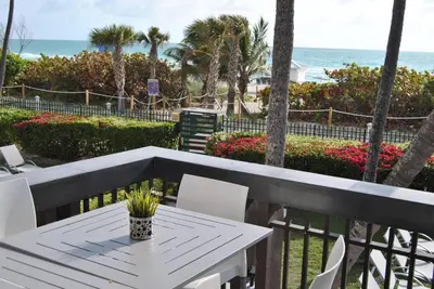 a table and chairs on a balcony with the beach at Ocean front 2 Bedroom and 2 Bathroom apartment at The Alexander Resort in Miami Beach