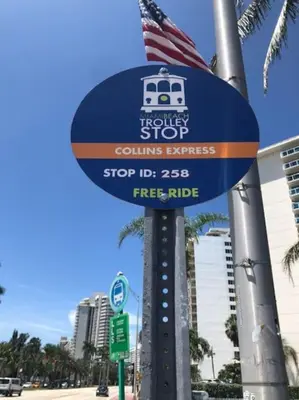 a sign for a bus stop on a city street at Beach Front Resort - 2 Bedroom, 2 bathrooms, Sleeps 6, 2 Pools- at The Alexander in Miami Beach