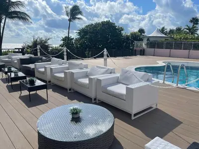 a group of white couches sitting next to a pool at Beach Front Resort - 2 Bedroom, 2 bathrooms, Sleeps 6, 2 Pools- at The Alexander in Miami Beach