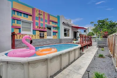 a swimming pool with a pink flamingo in front of a building at 5 Mins Brickell - Pool & Billiards - Retro Miami in Miami