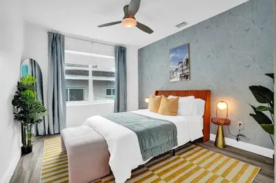 a bedroom with a bed and a ceiling fan at 5 Mins Brickell - Pool & Billiards - Retro Miami in Miami