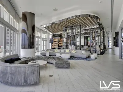 a lobby with couches and tables in a building at W FTL 1409 Beachfront Resort 2 Bedroom & 2 Bathroom Condo in Fort Lauderdale