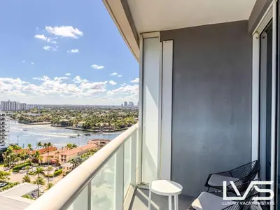 an apartment balcony with a view of the water at W FTL 1409 Beachfront Resort 2 Bedroom & 2 Bathroom Condo in Fort Lauderdale