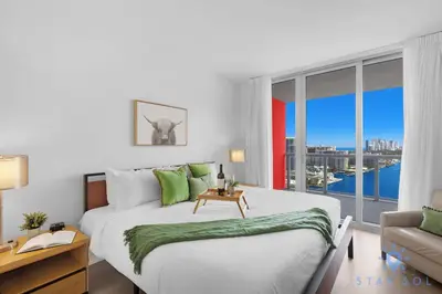 a bedroom with a large bed and a large window at Infinite View Amazing Apt Spectacular Amenities in Hallandale Beach
