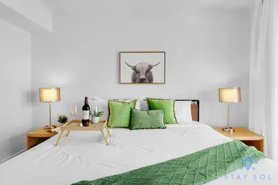 a bedroom with a large bed with green pillows at Infinite View Amazing Apt Spectacular Amenities in Hallandale Beach
