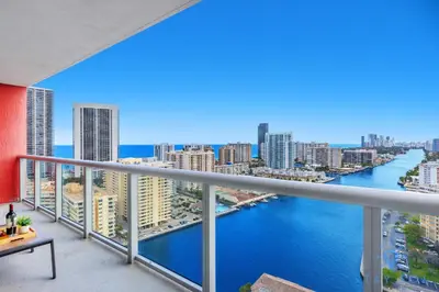 a balcony with a view of the ocean and buildings at Infinite View Amazing Apt Spectacular Amenities in Hallandale Beach