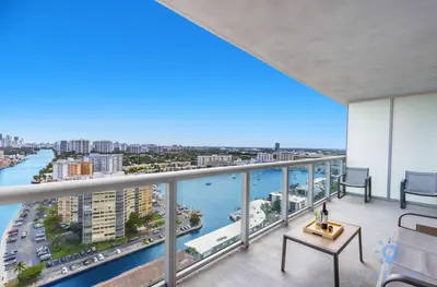 an apartment balcony with a view of the water at Spectacular Apt Infinity View Amazing Amenities in Hallandale Beach