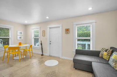 a living room with a couch and a table at Renovated Grove Bungalow -near Coconut Grove in Miami