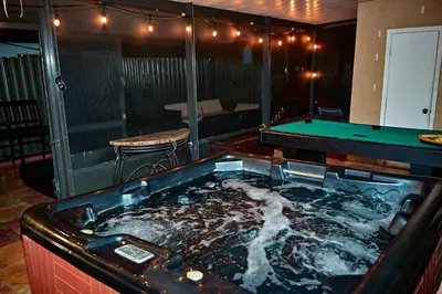 a bath tub with a pool table in a room at Luxury home 5 minutes from stadium in Miami