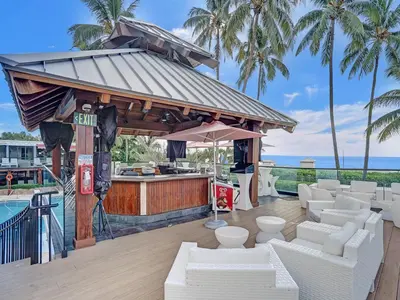 a bar with white couches in front of a pool at Luxury Penthouse 3BR 3BA Oceanfront PH7 in Miami Beach